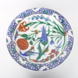 A Middle Eastern Iznik polychrome glazed plate with exotic bird decoration, diameter 31cm Hairline