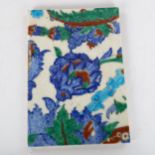 A Middle Eastern Iznik pottery tile, 24cm x 16cm Several glaze chips on the long edges, no