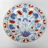 A Middle Eastern Iznik polychrome glazed pottery plate with floral design, diameter 31cm Good