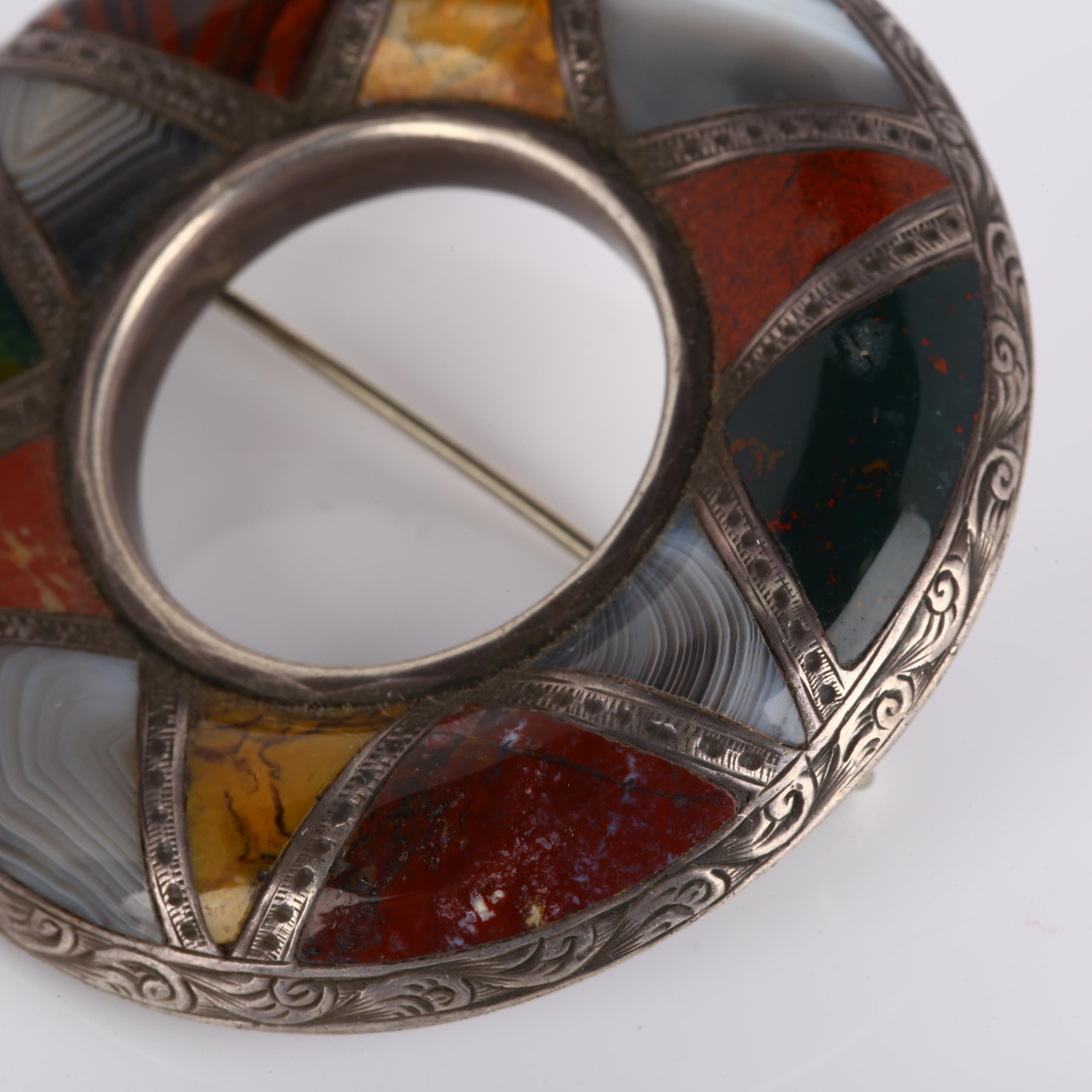 A 19th century Scottish hardstone brooch, unmarked silver closed-back settings in circular form, - Image 2 of 4