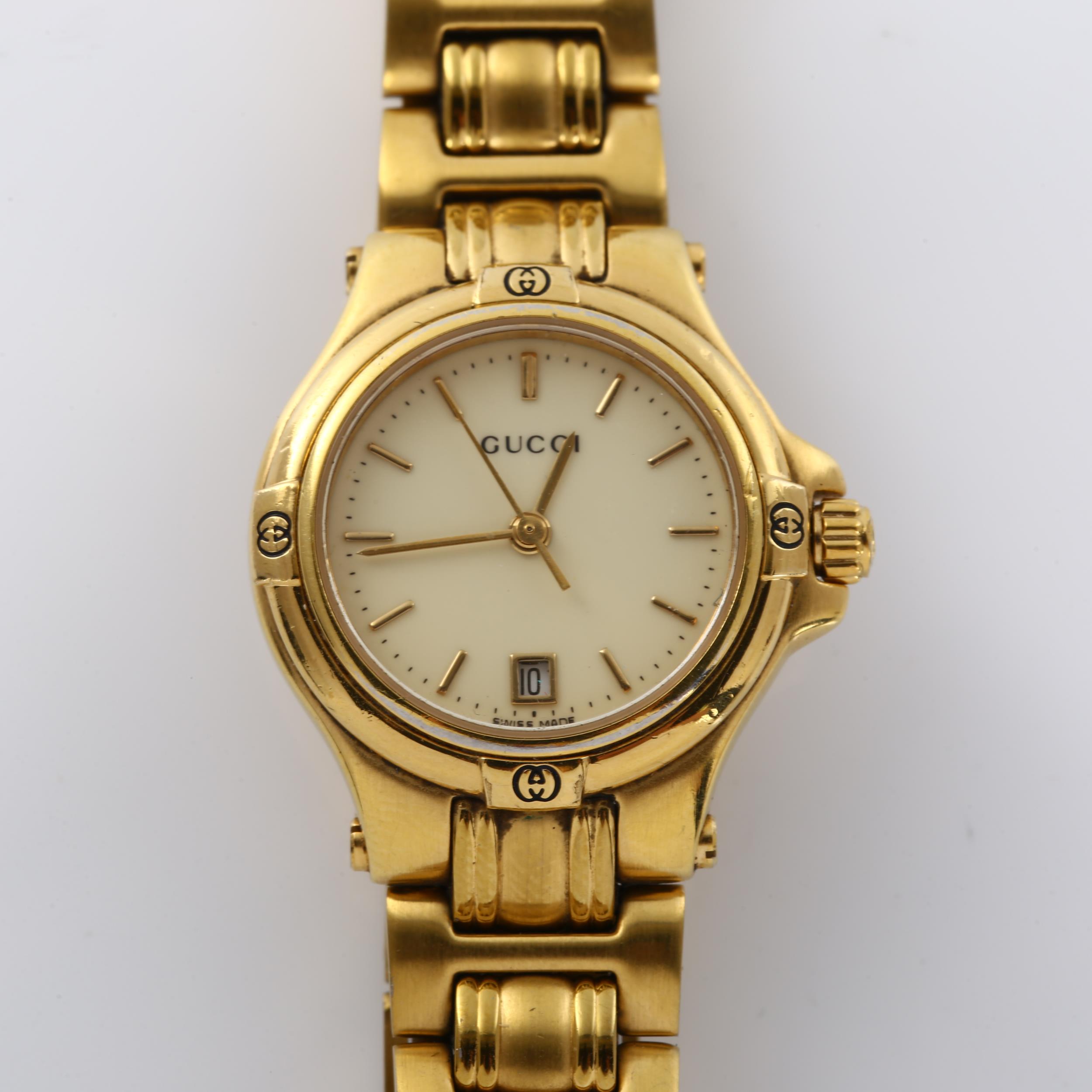 GUCCI - a lady's gold plated 9240L quartz bracelet watch, cream dial with gilded baton hour markers,