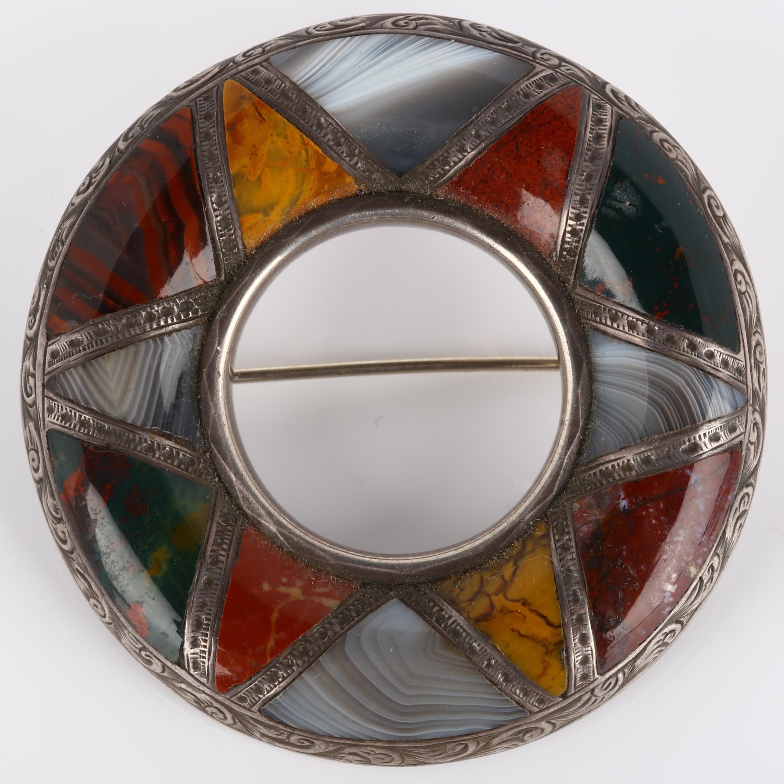 A 19th century Scottish hardstone brooch, unmarked silver closed-back settings in circular form,