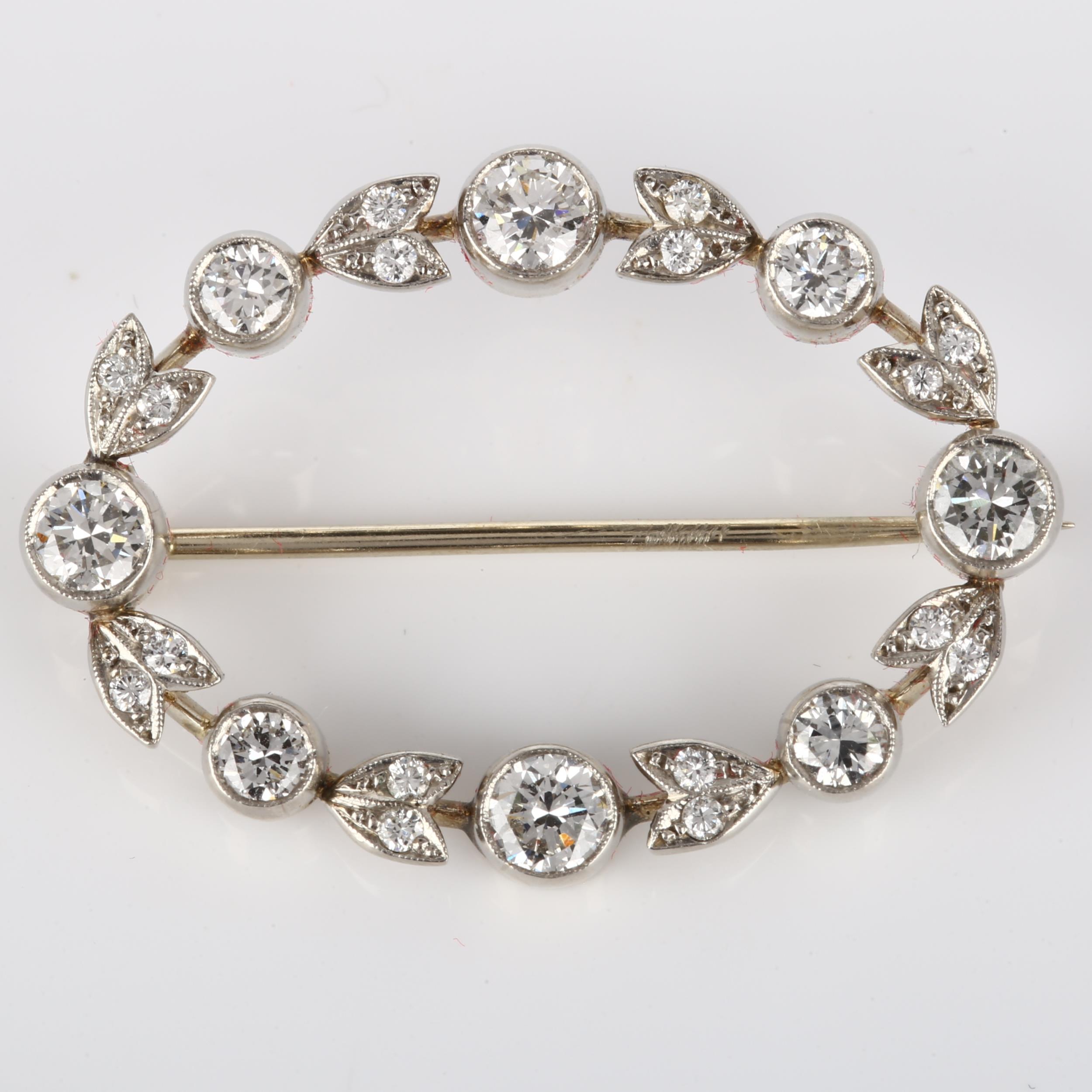 A Belle Epoque diamond brooch, openwork oval form with floral design set with modern round