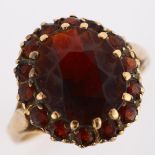 A late 20th century 9ct gold garnet cluster dress ring, setting height 16.6mm, size O, 4.6g No