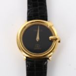 GUUCI - a lady's gold plated quartz wristwatch, black dial with G-shaped case, serial no. 313600413,