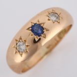 An early 20th century 15ct rose gold three stone sapphire and diamond gypsy ring, total diamond
