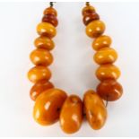 A large Tribal prayer bead necklace, probably Bakelite, largest bead diameter 62.9mm, necklace