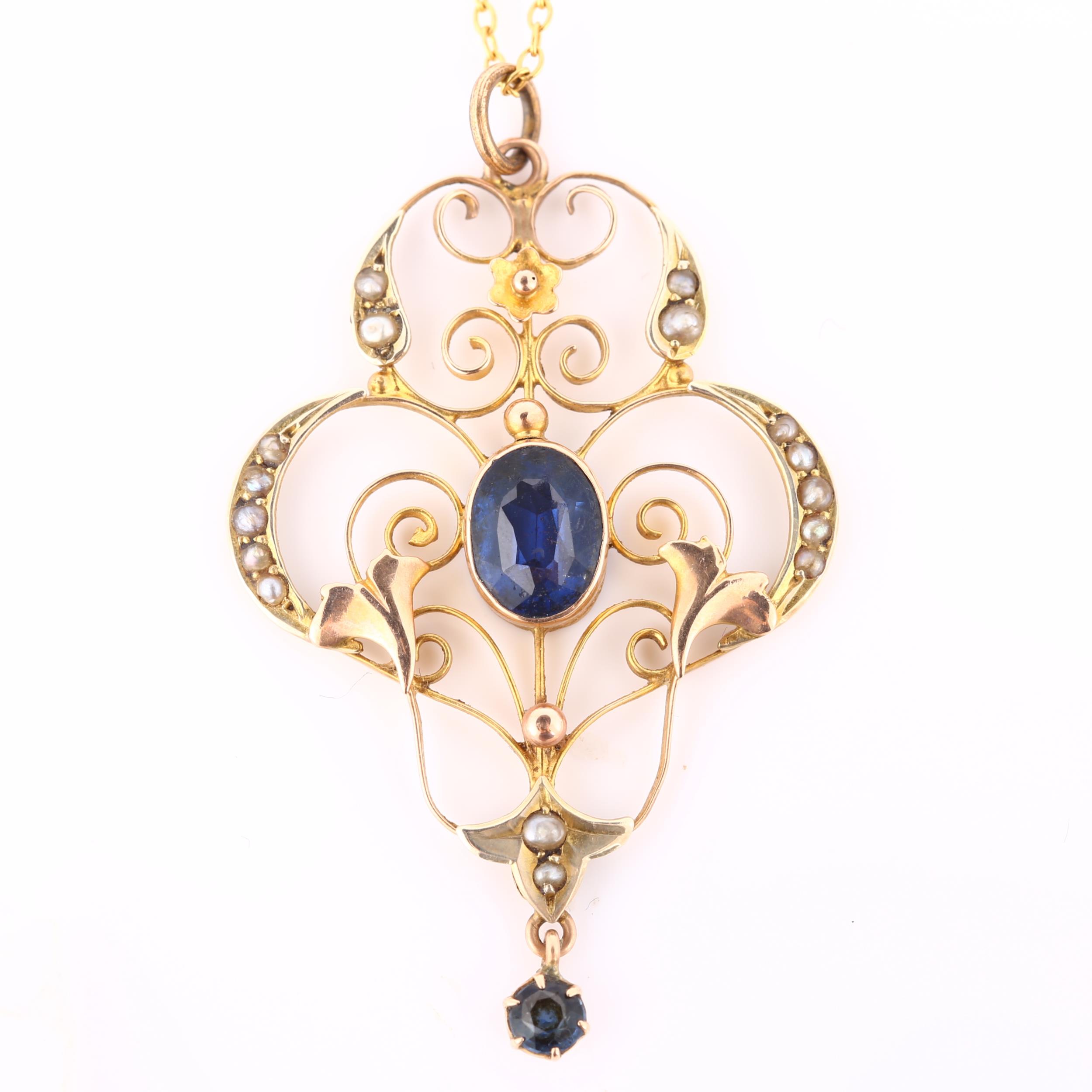 An Edwardian Art Nouveau 9ct gold stone set openwork pendant necklace, set with oval mixed-cut