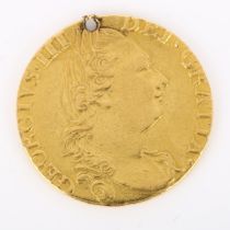 A George III 1782 gold guinea coin, 8.2g Coin has been pierced above head, high points slightly worn