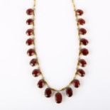 An Edwardian garnet fringe necklace, unmarked yellow metal settings with graduated oval mixed-cut
