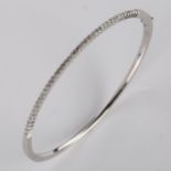 A modern 9ct white gold diamond hinged bangle, set with modern round brilliant-cut diamonds, band