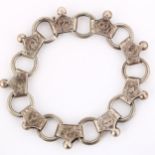 A Victorian fancy link chain bracelet, unmarked silver settings with engraved floral decoration,