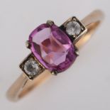 A three stone synthetic pink and white sapphire dress ring, unmarked rose metal settings with oval