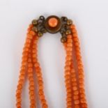 A triple-strand graduated coral bead necklace, with gilt-metal clasp, beads ranging from 6.3mm - 2.