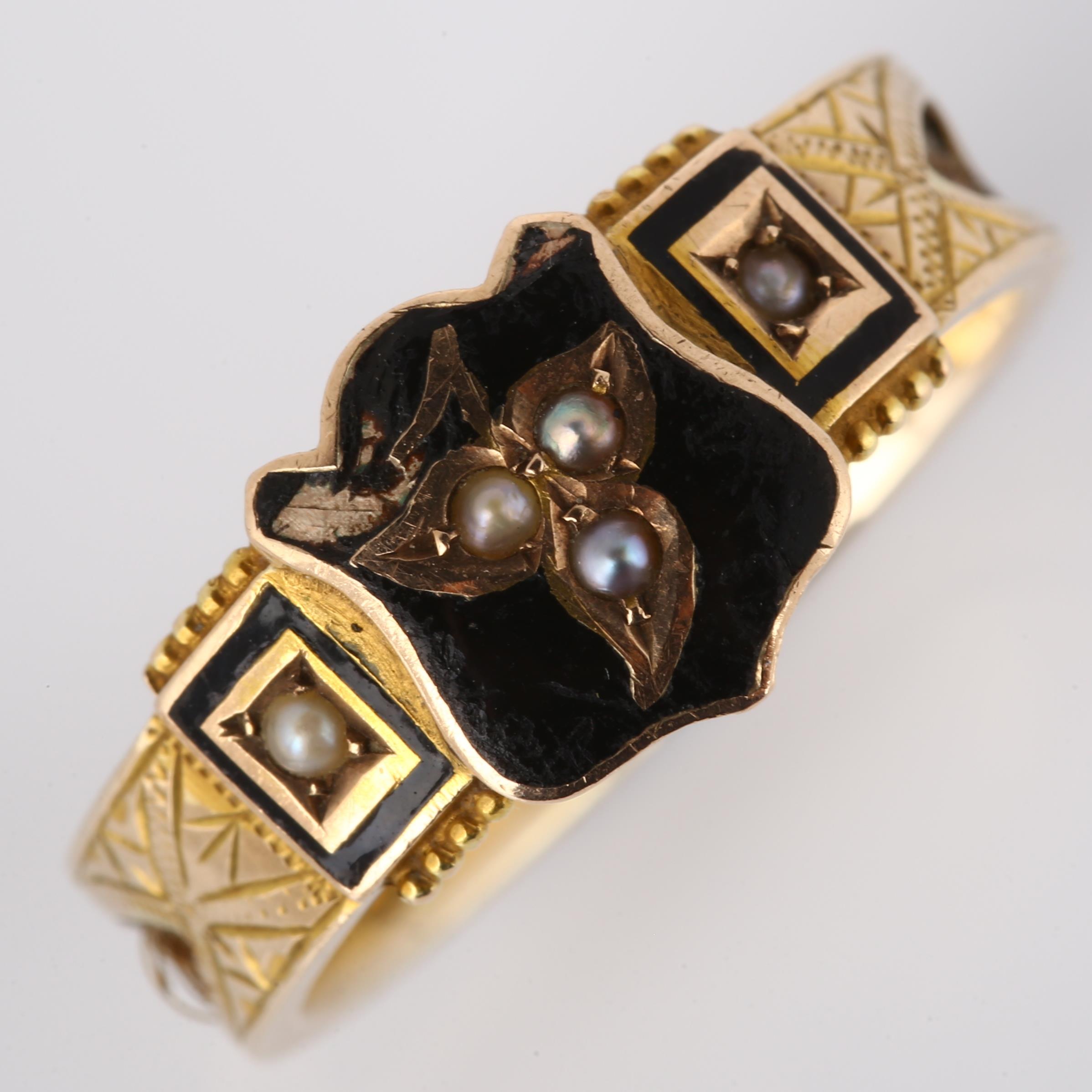 A 9ct gold pearl, black enamel and hair mourning ring, with inset woven hair shank and central