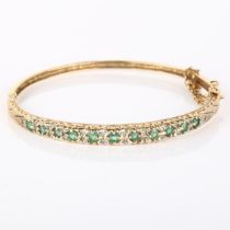 A 9ct gold emerald and diamond hinged bangle, set with round-cut emerald and single-cut diamonds,