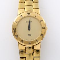 GUCCI - a lady's gold plated 3300L quartz bracelet watch, champagne dial with blue hands and Roman