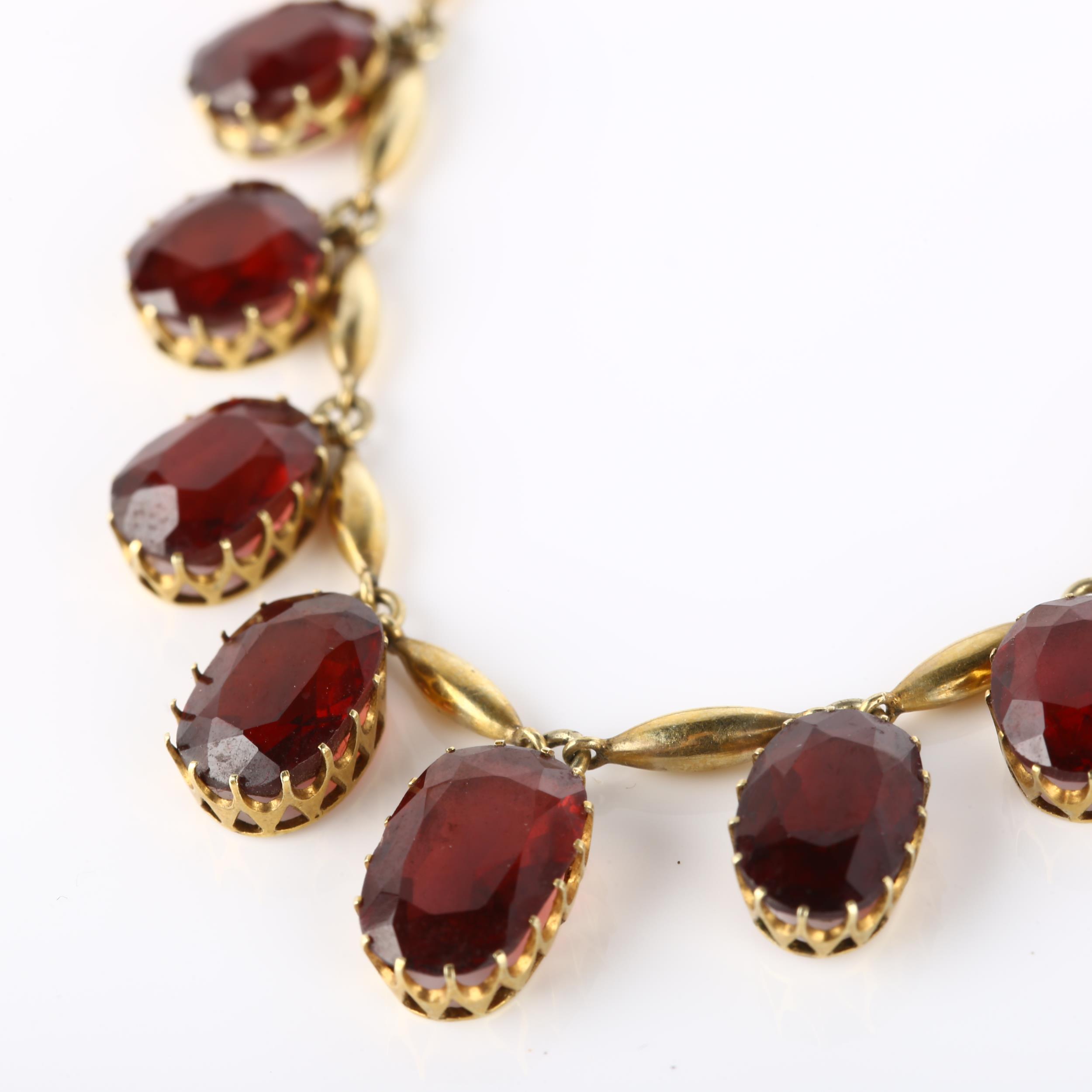 An Edwardian garnet fringe necklace, unmarked yellow metal settings with graduated oval mixed-cut - Image 2 of 4