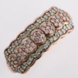 A modern 9ct rose gold diamond cluster band ring, set with modern round brilliant-cut diamonds,