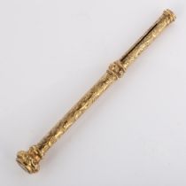 A 19th century propelling pencil, unmarked yellow metal settings with engraved foliate decoration