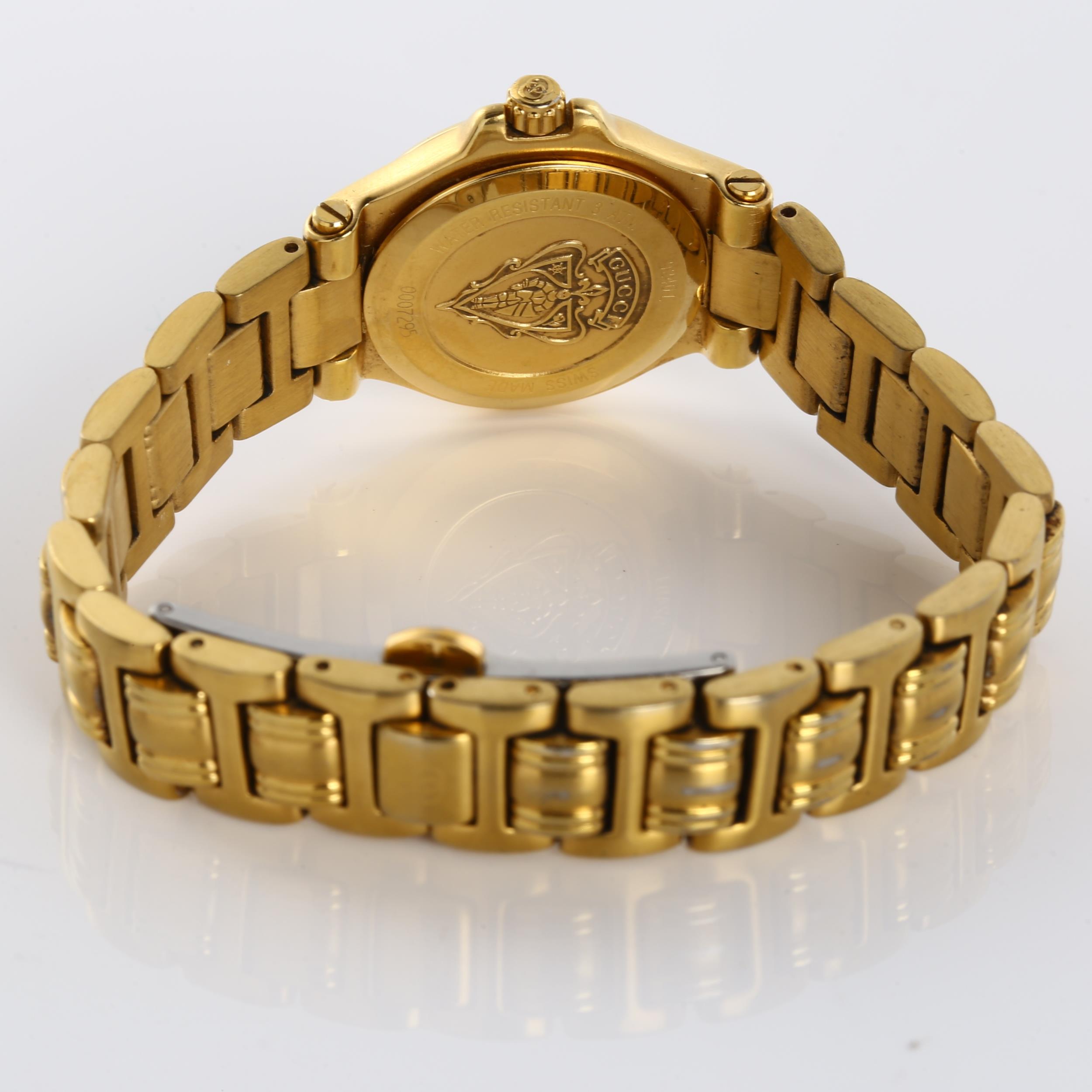 GUCCI - a lady's gold plated 9240L quartz bracelet watch, cream dial with gilded baton hour markers, - Image 4 of 5