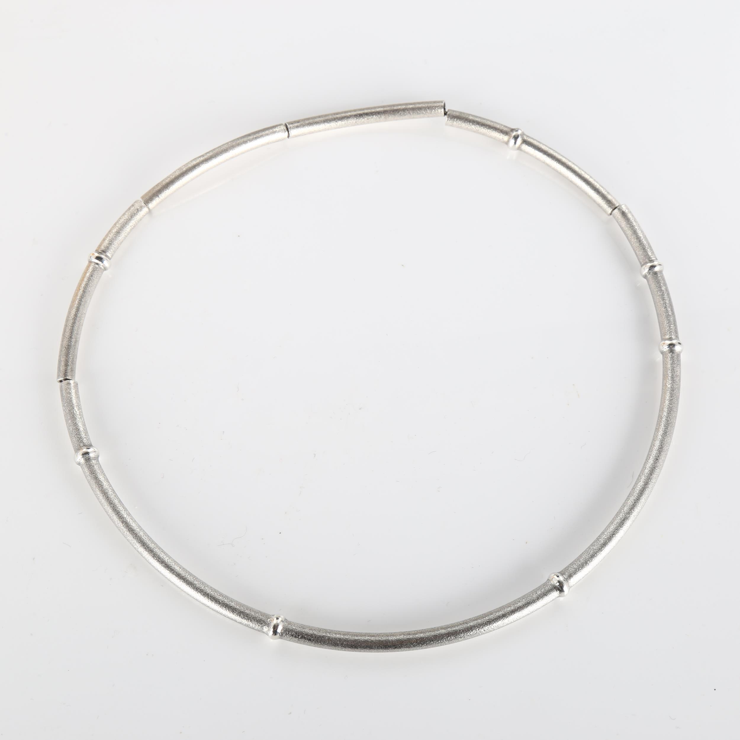 LAPPONIA - a Finnish sterling silver necklace, segmented form with textured ground and raised bands,