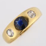 An early 20th century three stone synthetic sapphire and diamond gypsy ring, unmarked gold