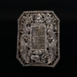 A Chinese dragon belt buckle, unmarked white metal settings with central character marks and pierced
