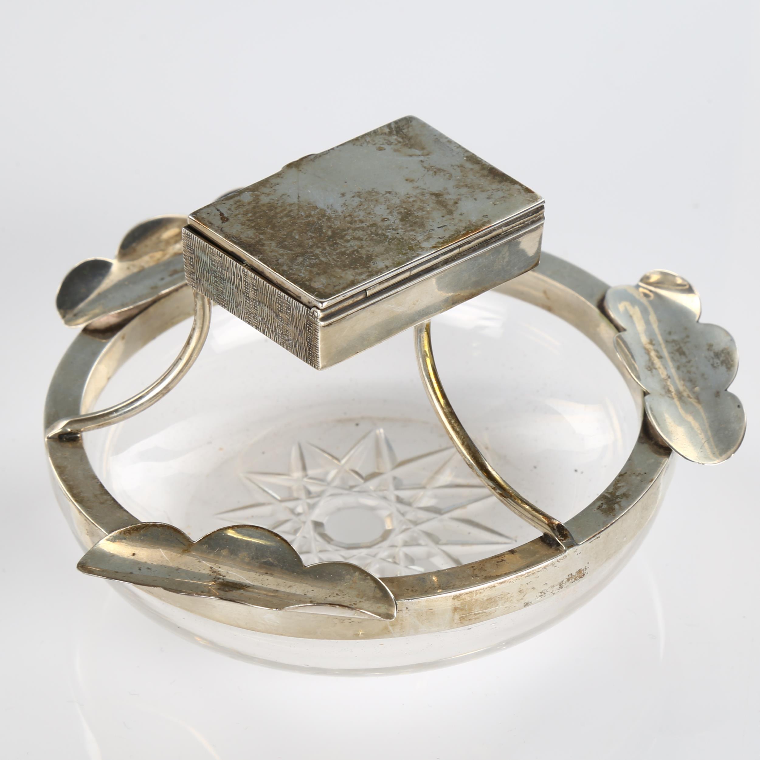 An Edwardian silver-mounted glass combination ashtray/matchbox, circular form with star base,