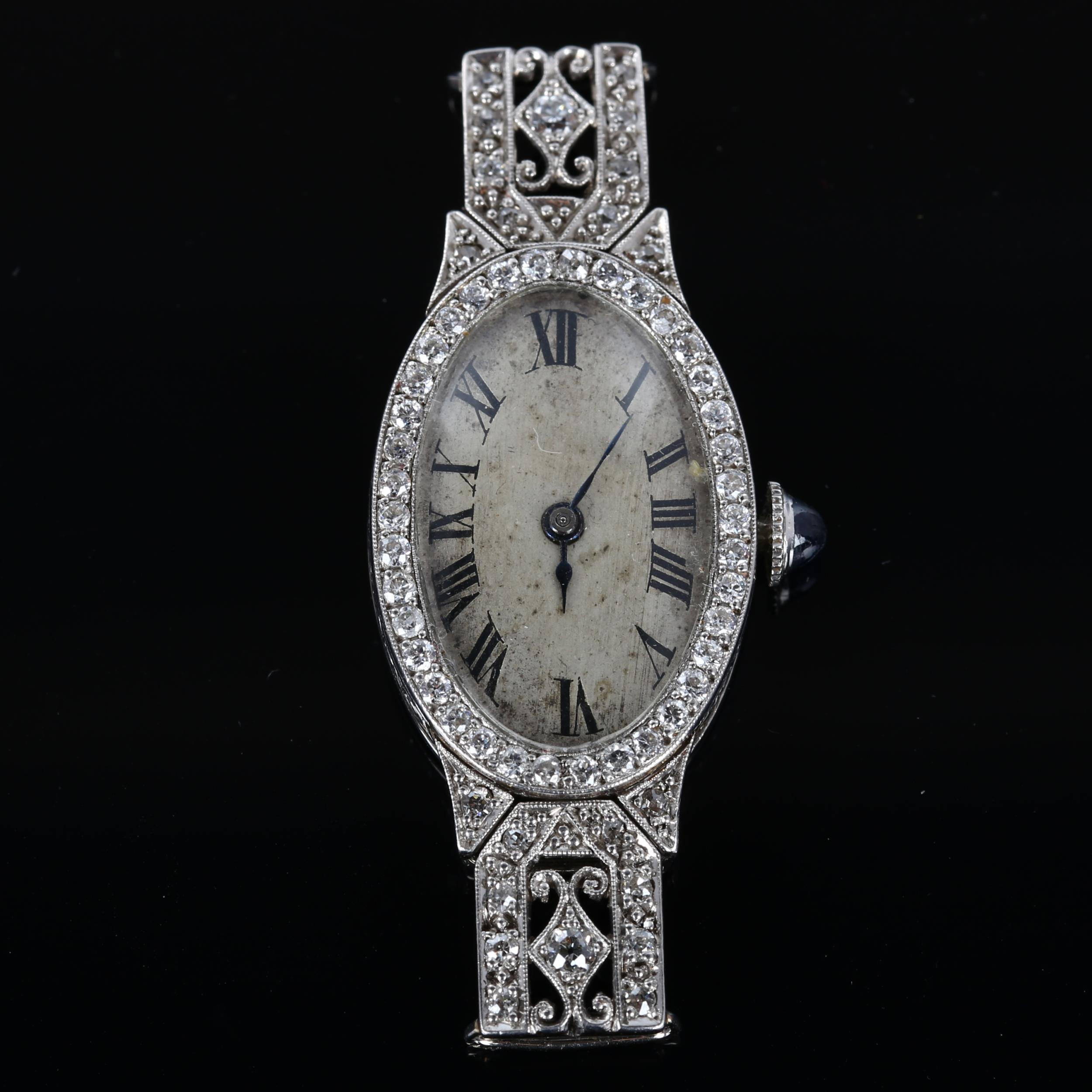 A lady's Art Deco diamond cocktail wristwatch head, oval silvered dial with Roman numeral hour