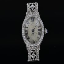 A lady's Art Deco diamond cocktail wristwatch head, oval silvered dial with Roman numeral hour