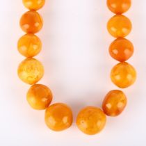 A graduated single-strand butterscotch amber bead necklace, beads ranging from 26.9mm to 23mm,