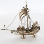 A 19th century German unmarked silver table Nef, the mastered ship with unfurled sales and armed