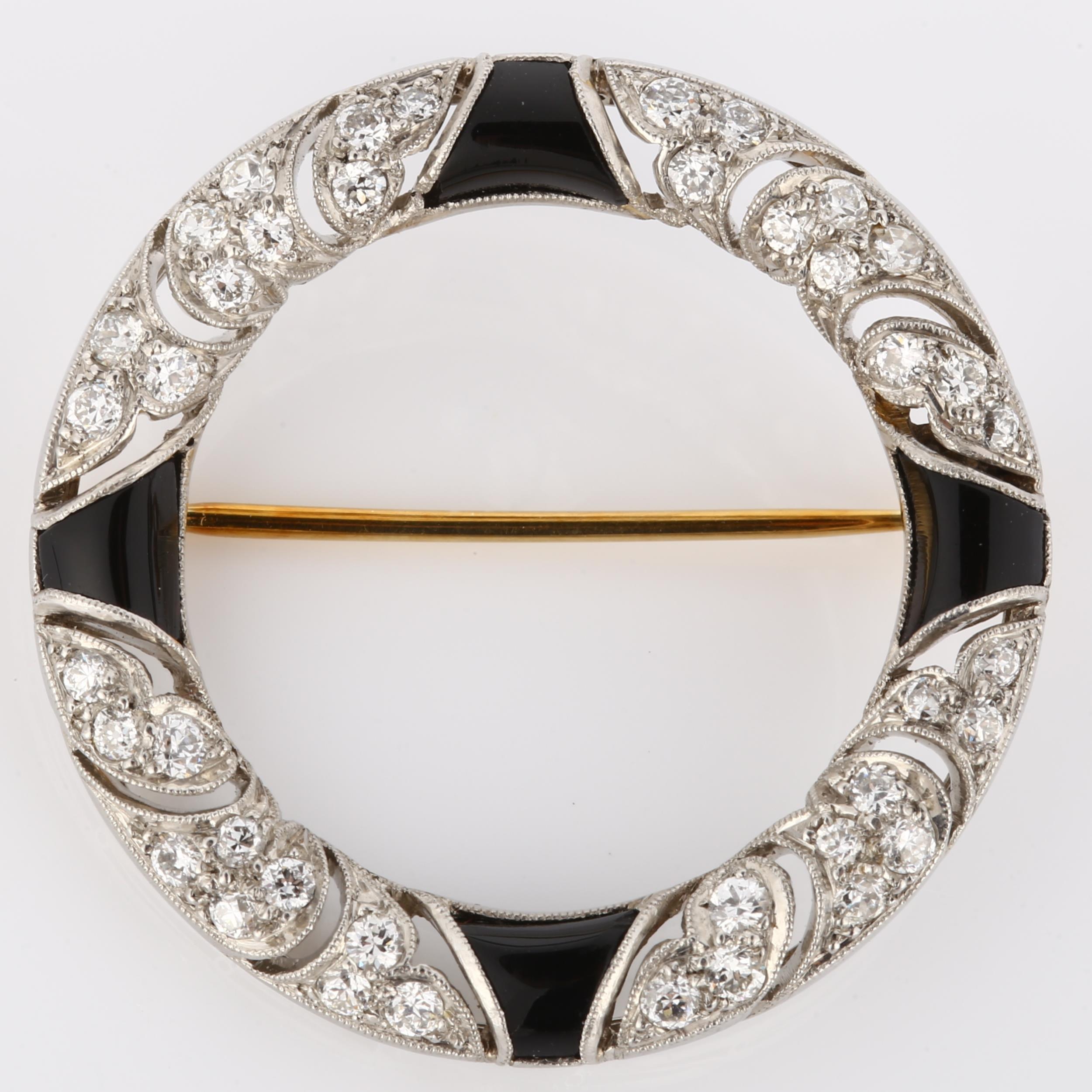 TIFFANY & CO - an Art Deco onyx and diamond brooch, unmarked white metal settings in circular