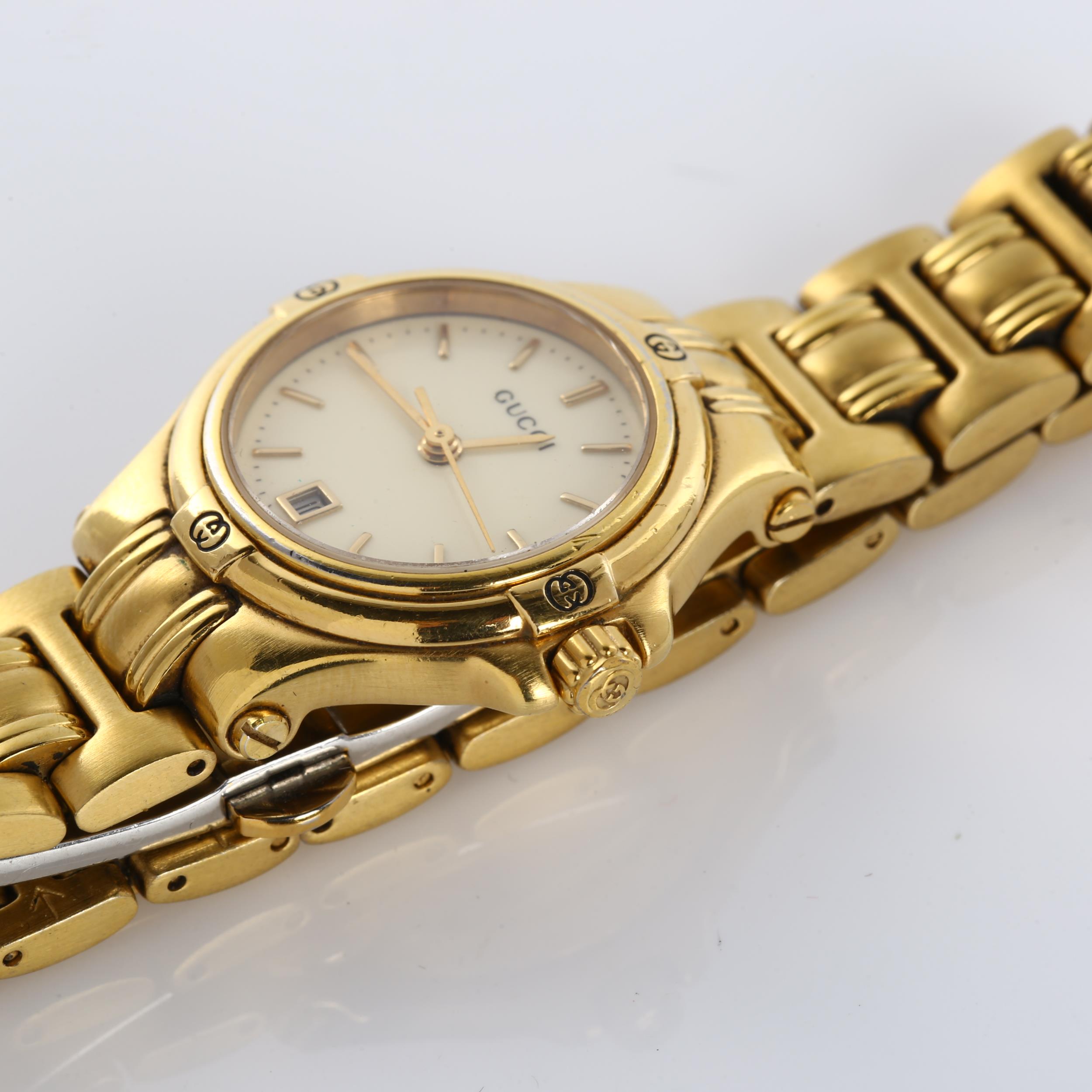 GUCCI - a lady's gold plated 9240L quartz bracelet watch, cream dial with gilded baton hour markers, - Image 3 of 5