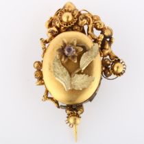 A Victorian Etruscan style mourning brooch, with stone set flower motif, cannetille surround and