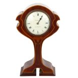 An Edwardian Art Nouveau mahogany-cased mantel clock of highly stylised form, with inlaid floral