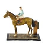 A cold painted metal racehorse and jockey design table lighter, base length 17.5cm