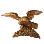 A Georgian carved giltwood eagle design pediment, wingspan 55cm