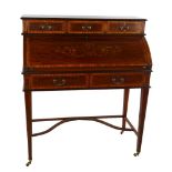 An Edwardian mahogany cylinder-front writing desk, with inlaid marquetry and banding on shaped