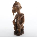An African carved wood Tribal fertility figure feeding twins, height 19cm, early to mid-20th century
