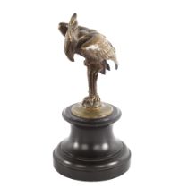 A 19th century patinated bronze sculpture of a heron, unsigned, on black slate socle base, height