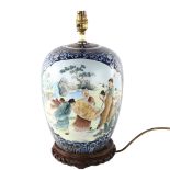 A Chinese porcelain lamp base on carved wood stand, height excluding fitting 32cm