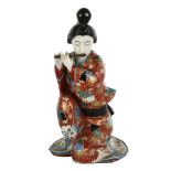 Japanese porcelain figure of a woman playing a flute, height 26cm Figure has lost tip of her