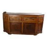 A 19th century oak dresser base, with canted ends, frieze drawers and panelled cupboards under,