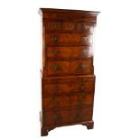 A 19th century walnut chest on chest of small size, with brushing slide and pierced brass drop