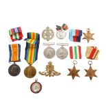 A collection of Great War and Second World War General Service medals, cap badges and medallions. Fi