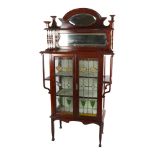 An Edwardian Art Nouveau display cabinet, with mirror inset spindled back and leadlight glazed