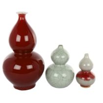 3 Chinese sang de boeuf and celadon glaze double-gourd vases, largest height 32cm, smallest 15cm (3)
