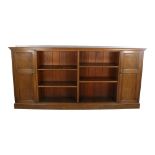 A long Edwardian oak open bookcase, with panelled cupboards to either end, length 223cm, height